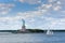 View of the Statue of Liberty in New York City, with a tugboat in the Hudson River