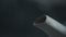 View of steam jets emerging from the spout of a grey enamelled kettle on a dark background. Close-up macro. Kettle boil