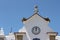 View of stocks nesting on the roof of a church on a blue sky background