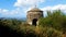 View of a stone chapel with greenery on a hill