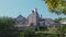 View of stone fortified tower with entrance gate to medieval Chateau royal de Montargis on hilltop on sunny summer day