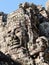 View of stone human faces, a notable feature on the towers of Cambodia\\\'s Khmer Bayon Temple