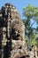 View of stone human faces, a notable feature on the towers of Khmer Bayon Temple
