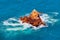 View of the stone islet near the Atlantic Ocean coast in Morocco in sunny day