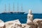 View with stone sculpture of a mermaid in city of Piran and large sailing ship on background, Slovenia