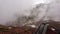 View of the strap backpack in the mountains. Clouds drift past. Snow is visible on the mountain slopes