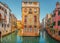 View of the street canal in Venice, Italy. Colorful facades of old Venice houses standing in water. Venice, Italy