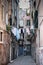 View of street with clothesline drying against building in Italy