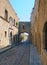 View of the street of the knights of rhodes lined with medieval buildings and an archway joining buildings