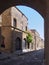 View of the street of the knights of rhodes lined with medieval buildings viewed through an archway