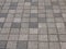 View of street pavement or a sidewalk made from small square bricks outdoors