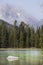 A view of String Lake in Grand Teton National Park with a white rock and mountains in the back.