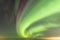 View of Strong Northern Lights and atmospheric phenomenon `STEVE` meets Milky Way. Steve appears as a purple and green light