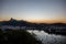 View from Sugarloaf mountain at dusk just after sunset overlooking boats on Guanabara bay & the city & mountains of Rio de Janeiro