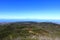 View from the summit of Garajonay on charred shrubs and trees, traces of the forest fire of 2012, on the horizon the island of La