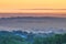 View of a sunrise above the Peten jungle with the pyramids of Tikal towering above the tree canopy in Guatemala