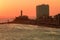 View of the sunset on the beach bar with the Barra Lighthouse in the background