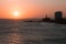 View of the sunset on the beach bar with the Barra Lighthouse in the background