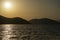 View of a sunset over Aegean Sea Greek islands. Hills silhouette