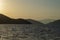 View of a sunset over Aegean Sea Greek islands. Hills silhouette