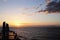 View of the sunset from the ship underway and in the port. Colorful views of the surface of the water and the sky with clouds.