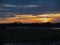 View with sunshine behind rice field.