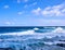 View of a surfer enjoying the strong waves of Hawaiian ocean