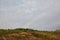 View of the surrounding hills and meadows in autumn, rainbow