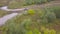 View of SUV driving into puddle. Clip. Top view of SUV driving into puddle of mud at races. Off-road racing in open