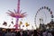 The view of Swing ride tower and Ferris wheel at Sydney Royal Easter show in twilight time.