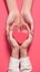 view Symbolic gesture of care adult and child hands clasp a heart