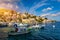 View on Symi Simi island harbor port, classical ship yachts, houses on island hills, Aegean Sea bay. Greece islands holidays