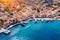 View on Symi Simi island harbor port, classical ship yachts, houses on island hills, Aegean Sea bay. Greece islands holidays