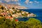 View on Symi Simi island harbor port, classical ship yachts, houses on island hills, Aegean Sea bay. Greece islands holidays