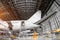 View of the tail passenger aircraft on service in an aviation hangar rear, ladder entrance