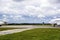 View of the take-off field and two planes going on a runway in cloudy summer afternoon.