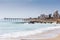 View taken from Humewood beach towards Hobie beach with Shark Rock Pier, buildings and restaurants in background with old slipway