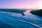 View of Tallebudgera creek mouth and ocean coastline at sunset.