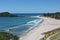 View of Tauranga from Mount Maunganui in New Zealand. The surf rolls on to the perfect sandy beach