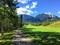 A view from the tee box looking down a tough par 4 lines with trees and the rocky mountains in the background.