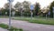 View of teenager rides on in-line skates at playground. Girl rides the bike at playground traffic. Little girl on bike