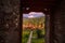 View through a temple doorway at sunset towards Pura Ulun Danu Tamblingan temple in the Buleleng Regency area of Bali, Indonesia,