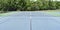 View of a tennis court net and empty tennis court