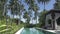 A view of the territory of the tropical resort with the pool palm trees