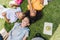 View of three happy multicultural schoolkids smiling while lying on lawn