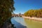 View of the Tiber river in Rome City with bridge crossing the river lined with green trees
