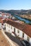 The view of tile roofs of Mertola with bridge across the valley