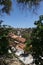 View of the tiled roofs of dense standing houses of the Antalya old city from south vegetation on a bright sunny day