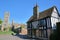 View of a timbered framed and medieval house in Ely UK with the West part of the Cathedral in the background