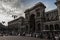 A view to the access of the gallery from the square in front of the famous Milan`s Cathedral. Evening is coming during a late summ